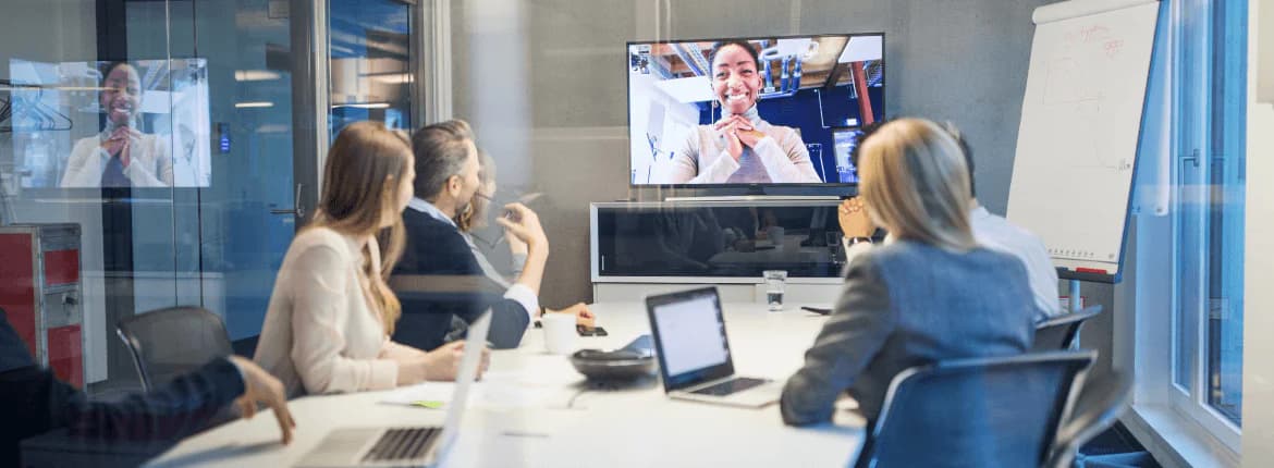 profissionais conversando em uma mesa de trabalho e fazendo videoconferência com fornecedor